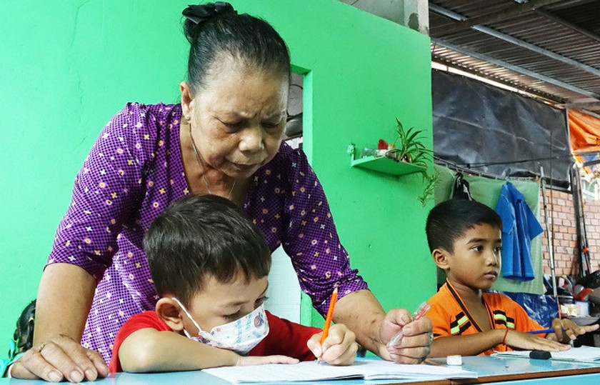 Cô Trần Thị Mươn dạy trẻ Khmer viết chữ tại lớp học tình thương của mình. image-6483441-4653
